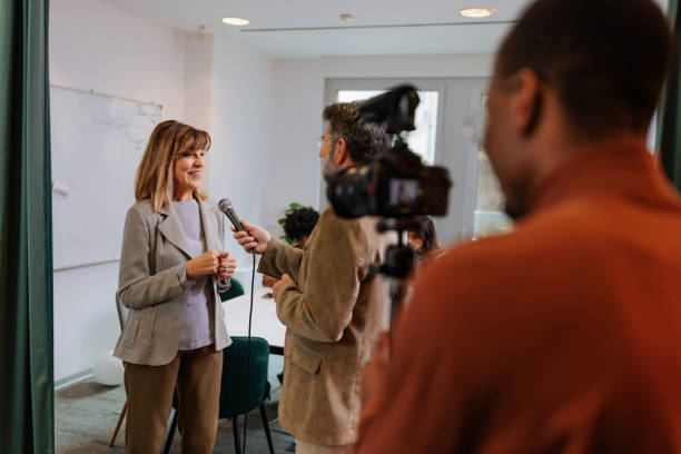 istock TV crew interviewing businesswoman 2160276516