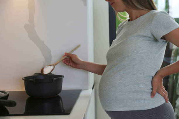 istock Pregnant woman in the kitchen. 2160277116