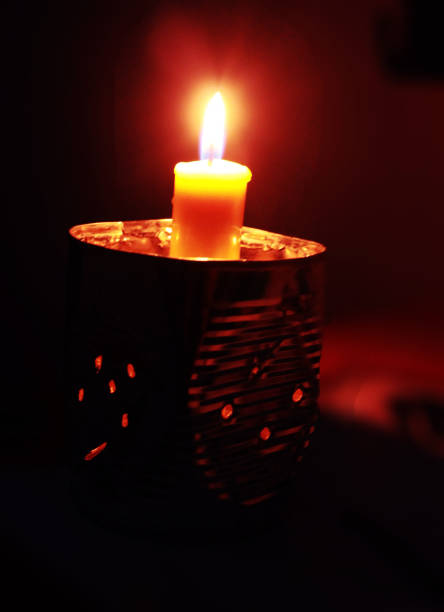 Paris, France: One Yellow Lit Candle, Black Background