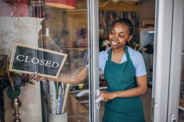 istock Smiling florist closing a flower shop 2160278785