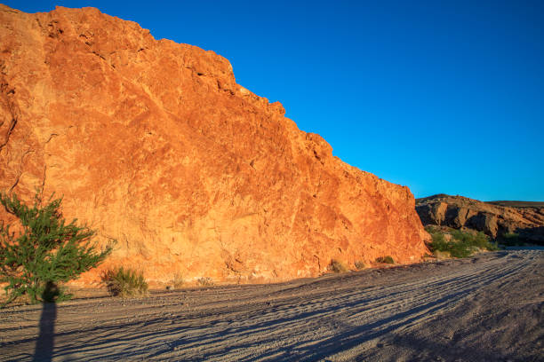 Off road trail   with red rock against sunset light