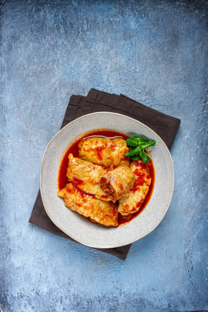 istock Stuffed cabbage rolls with minced meat, in tomato sauce, top view, without people, in the spotlight. 2160284998