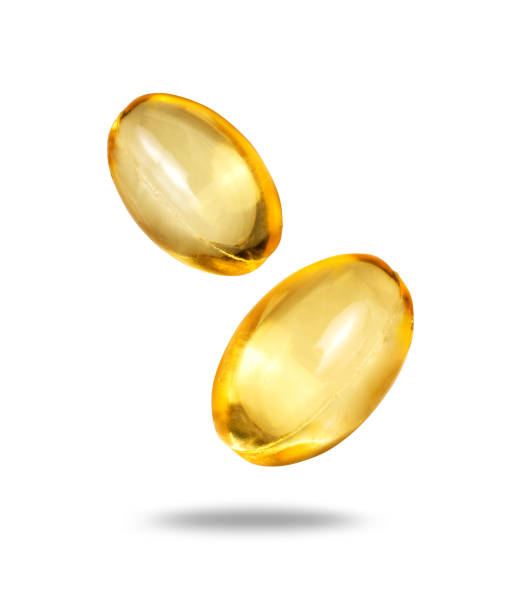 istock Two capsules with fish oil close up isolated on white background 2160285527