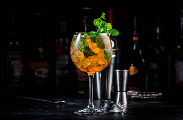 istock Summer refreshing cocktail drink with cognac, liqueur, sparkling wine with ice and mint in wine glass, dark background 2160293294