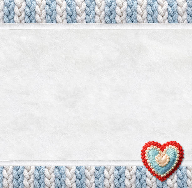 Vertical backdrop with suede texture, wool border with pigtailed ornament and felt heart. Christmas background with suede leather and plaited frame of light blue and white color. Copy space for text