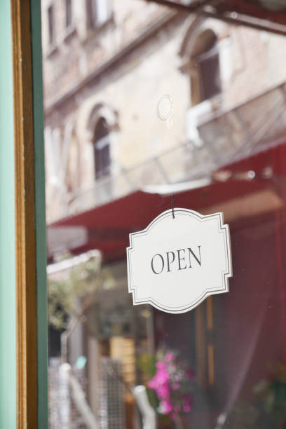 istock Open sign hanging front of cafe . 2160295069