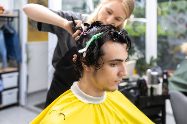 istock Young man getting a haircut at salon 2160299690