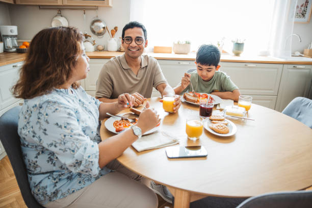 istock Family at home starting their day in the kitchen 2160305302