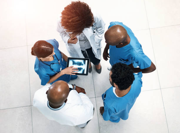 istock Top view, tablet screen and doctors in lobby, xray or teamwork for surgery feedback. Specialist, medical or professional with tech, advice or collaboration for healthcare, review results or people 2160305704