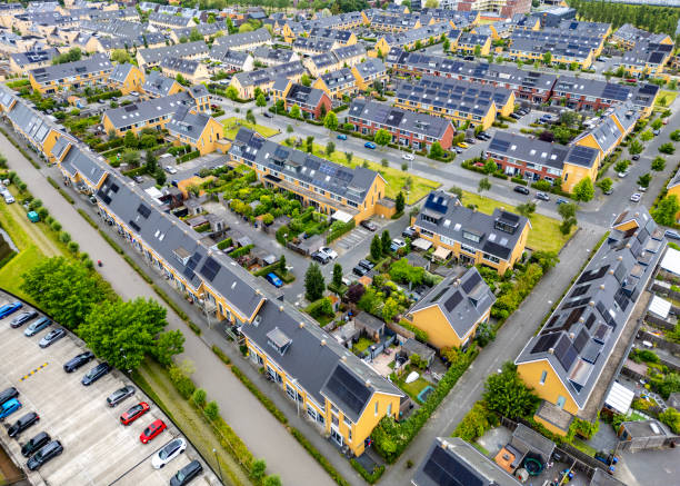 Facade in row of Modern Real Estate Family houses in a suburban area in the Netherlands.  Drone shot.