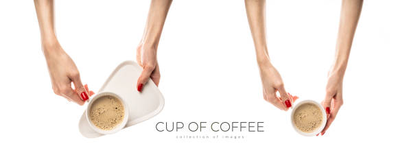 Female hands hold a white ceramic cup on white background. Female hands with fresh red manicure. Isolated on white background. High quality photo