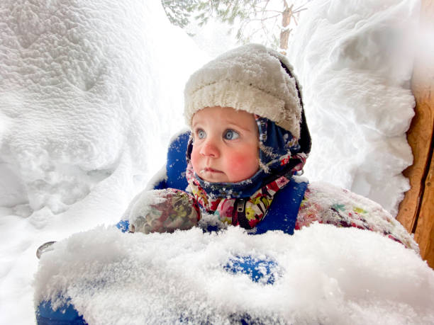 Young boy chrashed after making a big jump in the deep snow on a sunny day in the ski resort of St .Anton am Arlberg, Austria