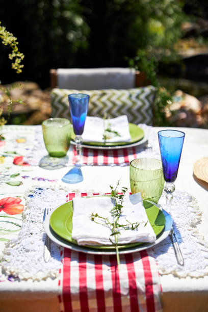 istock Bright summer holiday table setting in nature in the backyard, the table is decorated with wildflowers, daisies and fruits 2160307840