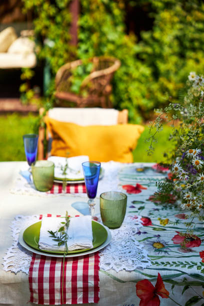 istock Bright summer holiday table setting in nature in the backyard, the table is decorated with wildflowers, daisies and fruits 2160308791