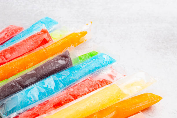Mulicolored Frozen Ice Pop Popsicle on a Kitchen Counter