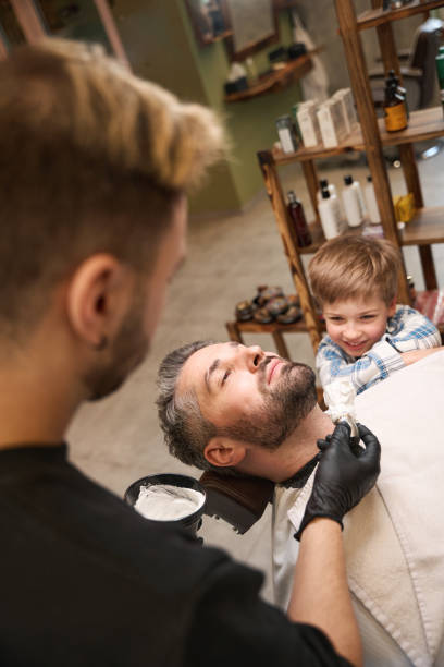 istock Barber going to apply shaving foam on the bearded man's face 2160317002