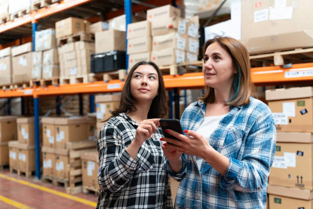 istock A customer family using a smartphone while scrolling through goods searching stock on the online shopping website or app in a retail warehouse market mall 2160320306