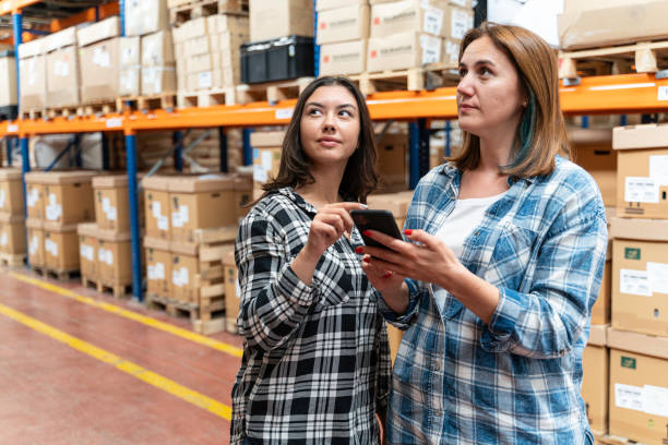 istock A customer family using a smartphone while scrolling through goods searching stock on the online shopping website or app in a retail warehouse market mall 2160320389