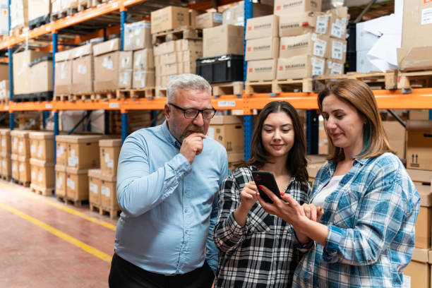 istock A customer family using a smartphone while scrolling through goods searching stock on the online shopping website or app in a retail warehouse market mall 2160320507