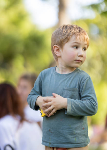 istock A young boy wearing a green shirt 2160320946