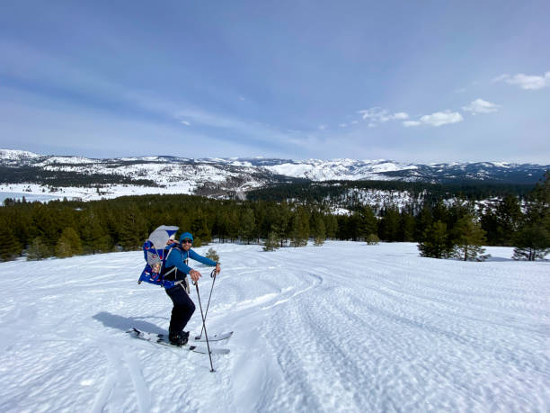 istock Father back country skiing with daughter 2160324803
