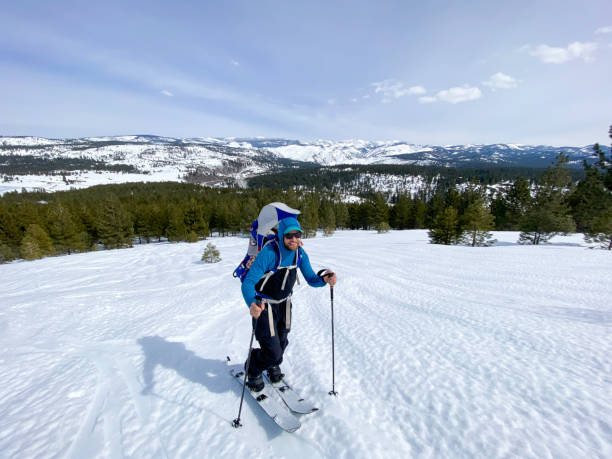 istock Father back country skiing with daughter 2160324808