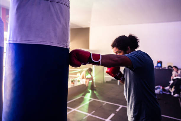 istock Mid adult man practicing fight in the gym 2160325084