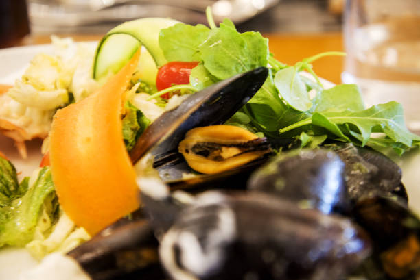istock mussel and salad on a plate 2160325273