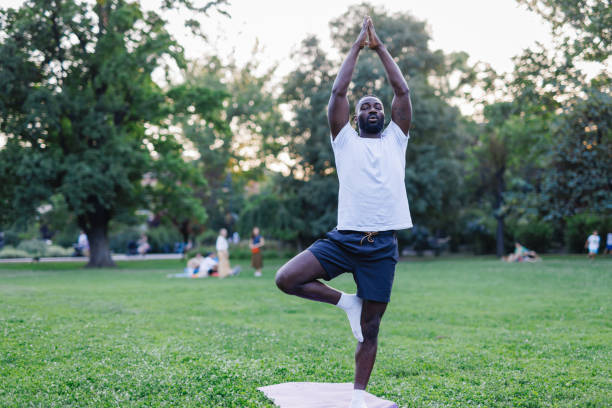 istock Yoga day outdoors with a man doing the tree pose. 2160325531
