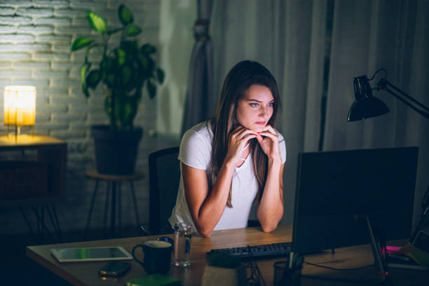 istock Young woman studying late at night for an exam 2160325636