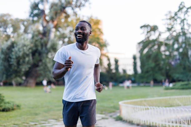 istock Happy athlete running outdoors amidst lush greenery 2160325716