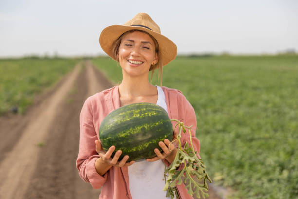 istock woman holding a freshly picked watermelon 2160327364