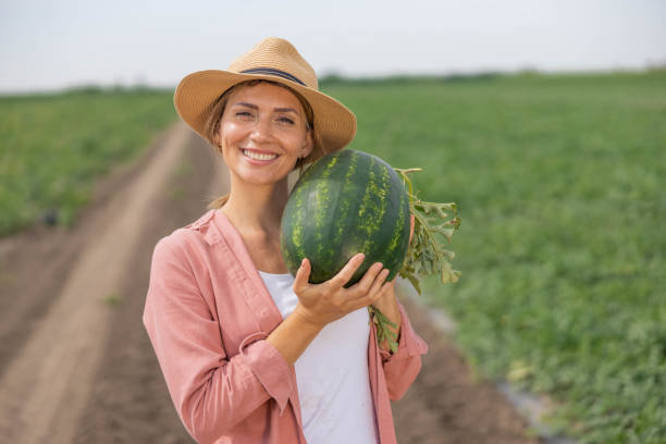 istock woman holding a freshly picked watermelon 2160327365