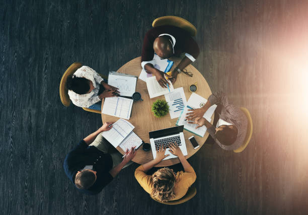 istock Top view, business people and teamwork with paperwork, charts and cooperation with reports. Group, employees and brainstorming with collaboration, development for ideas and support with conversation 2160328065