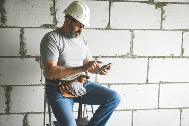 istock worker doing renovations in an apartment (tablet pc) 2160329392