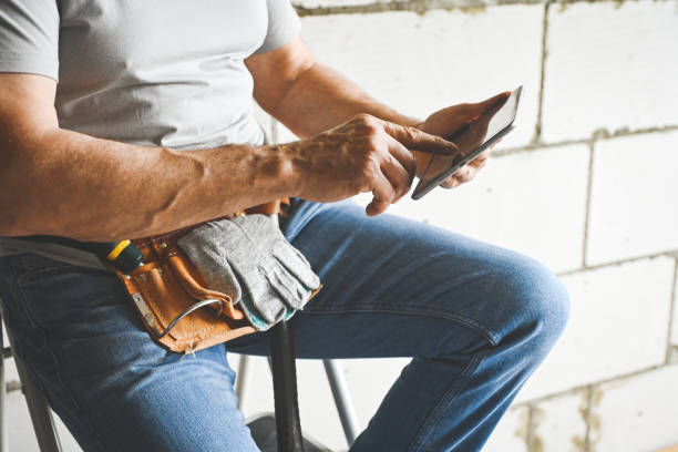 worker doing renovations in an apartment (tablet pc)