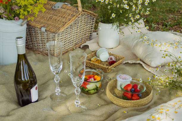 istock Beautiful white boho style decor. Picnic in nature on the grass under the tree 2160330981