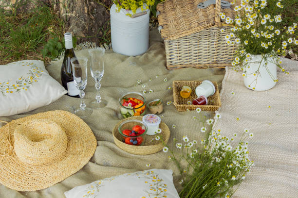 istock Beautiful white boho style decor. Picnic in nature on the grass under the tree 2160331483