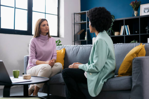 istock Woman on sofa talking to female psychologist 2160331721