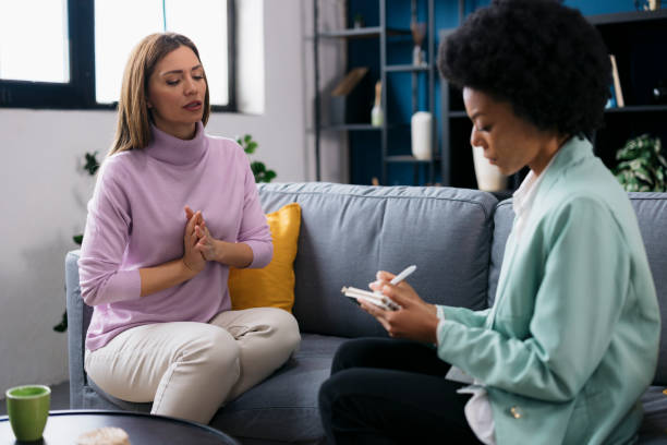 istock Stressed young woman with anxiety in therapy session 2160331722