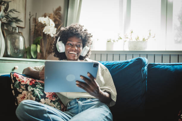 istock Young woman using a digital tablet at home 2160332736