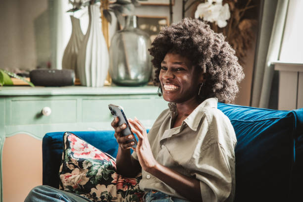 istock Young woman using a smart phone at home 2160332872