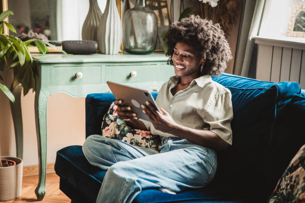 istock Young woman using a digital tablet at home 2160332876