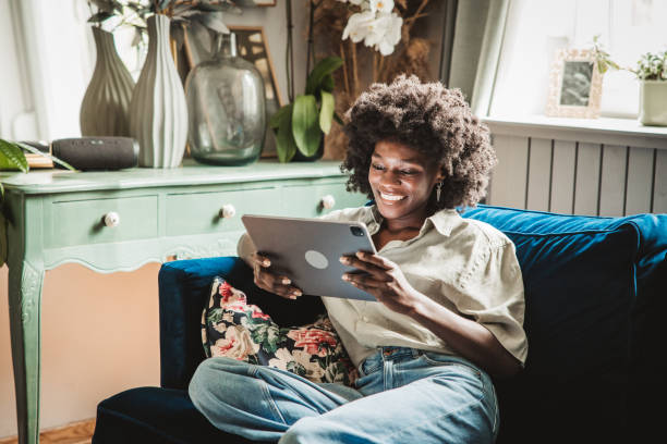istock Young woman using a digital tablet at home 2160332899