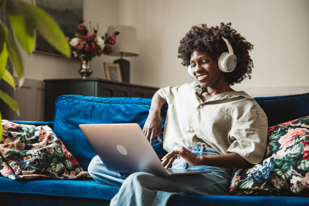 istock Young woman using a laptop at home 2160332915