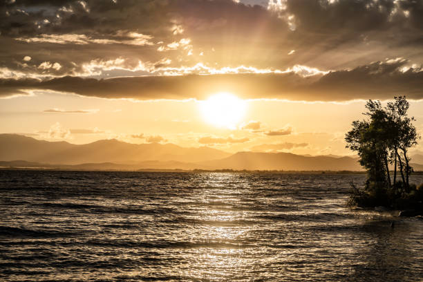 Bright Sunset Over Water Horizon Mountains