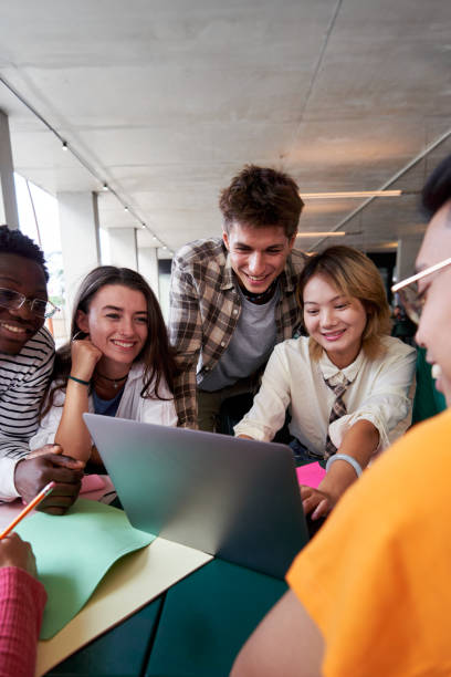 istock Multiracial group of university students sitting in the cafeteria studying together after classes. 2160333909