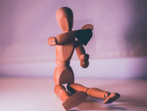 istock Articulated wooden dummy with a heart 2160333979