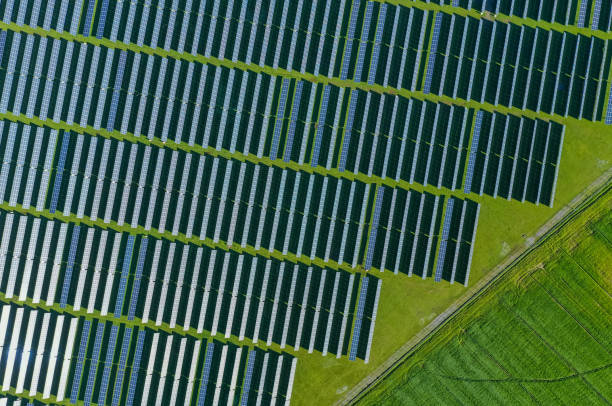 istock Solar panels on field in summer, aerial drone view 2160338007