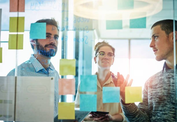 istock Group of people, presentation and planning in office for proposal, collaboration and teamwork. Coworkers, discussion and brainstorming for ideas, sticky note or project in creative agency for career 2160338121